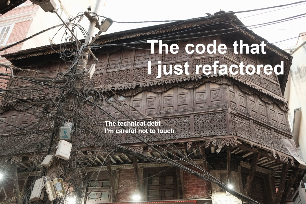 A beautiful facade covered in geometrical wood carvings, captioned "The code that I just refactored".  In front, a huge jumble of cables on a telephone pole, "The technical debt I'm careful not to touch".